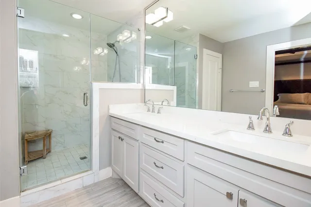 a bathroom with a double vanity sink and a mirror
