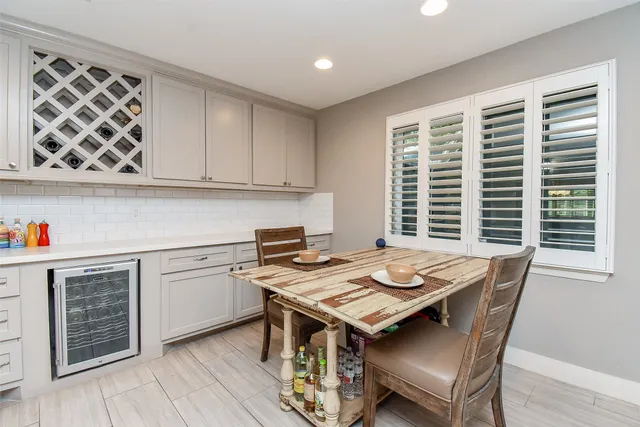 a kitchen with a stove a sink and wooden floor