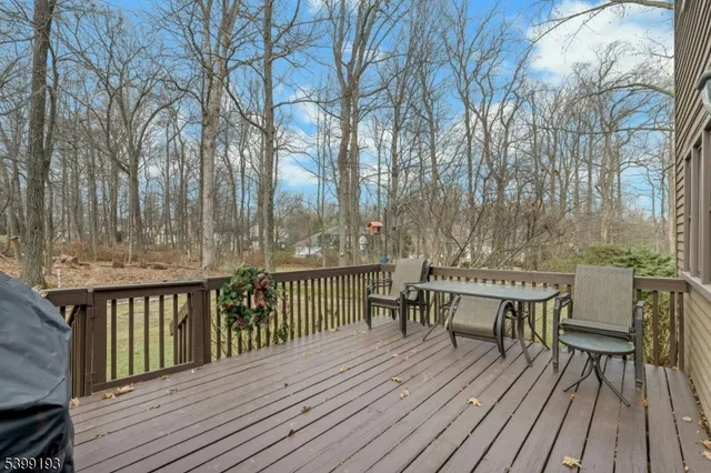 a view of backyard with two chairs and wooden floor