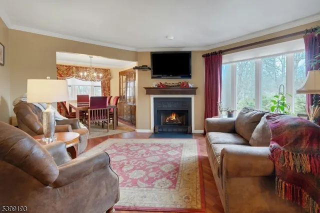 a living room with furniture a large window and a fireplace