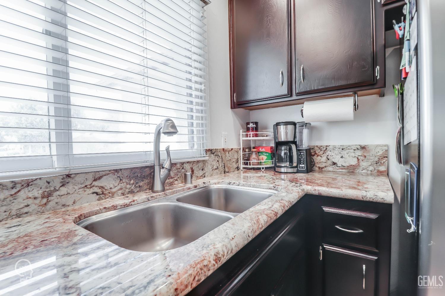 Undisclosed Address Bakersfield, CA 93311 - Photo 11 of 19 a kitchen with granite countertop a sink and a stove