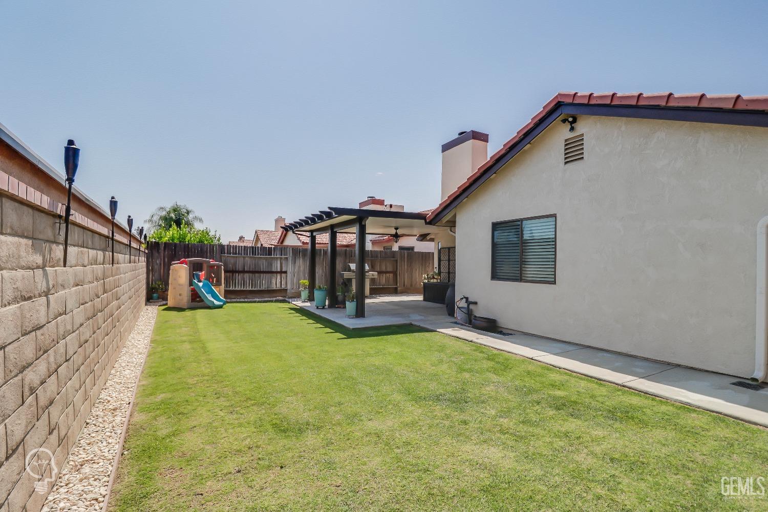 Undisclosed Address Bakersfield, CA 93311 - Photo 17 of 19 a view of a house with backyard and porch