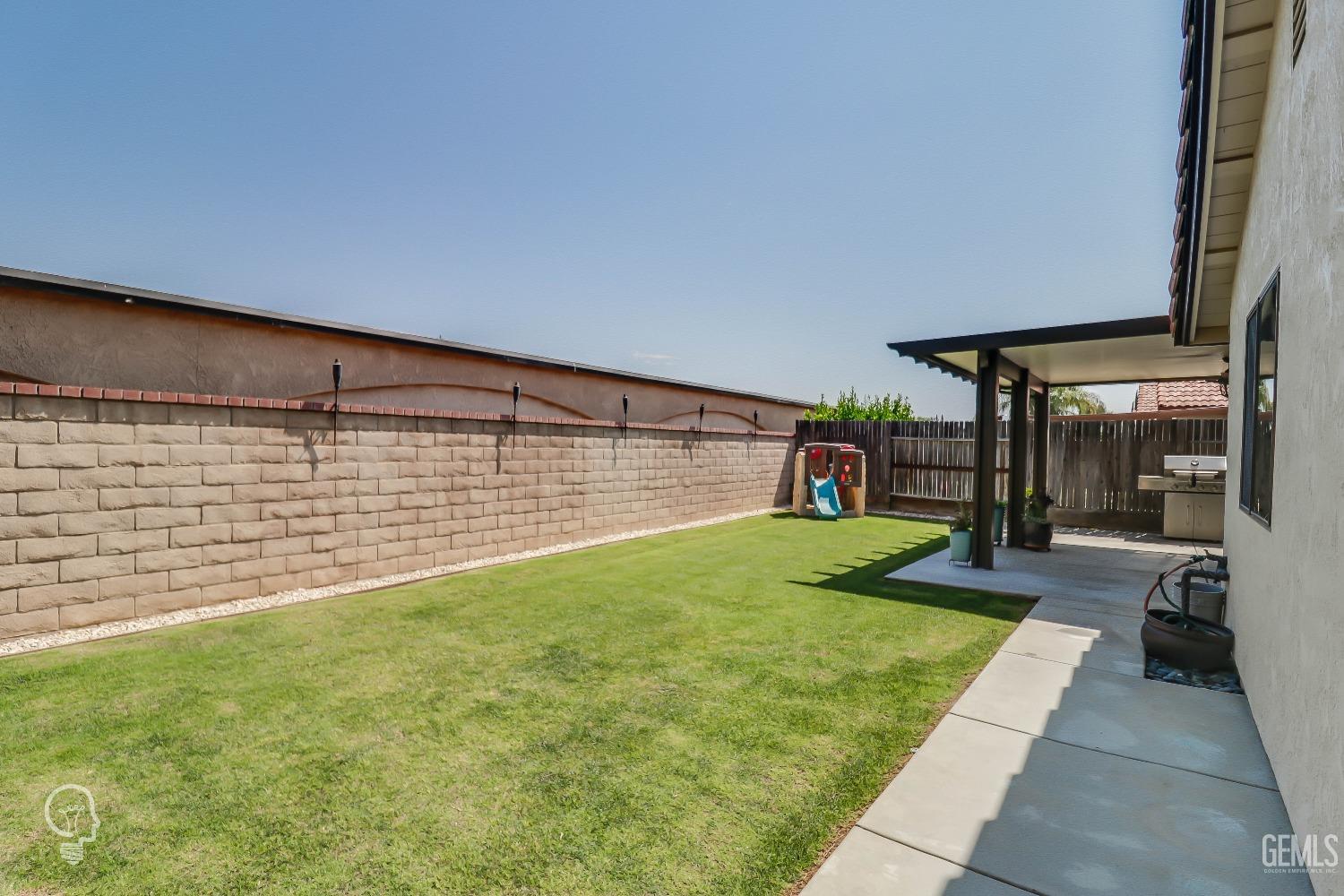 Undisclosed Address Bakersfield, CA 93311 - Photo 18 of 19 a view of a backyard with a garden and plants