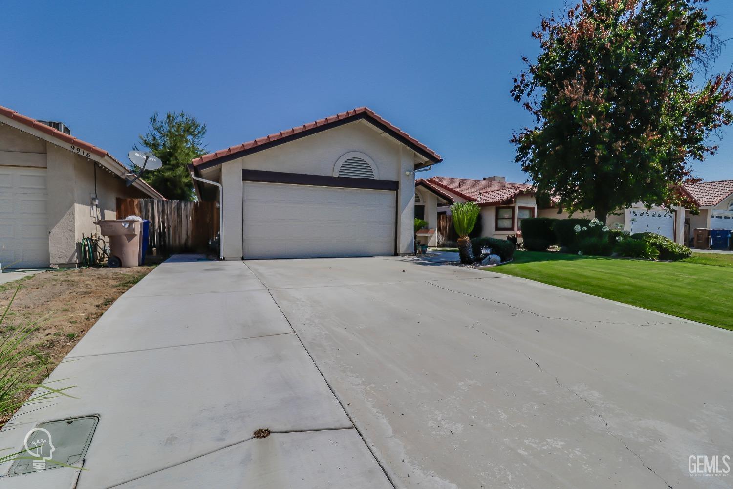 Undisclosed Address Bakersfield, CA 93311 - Photo 4 of 19 a view of a house with a yard and large trees