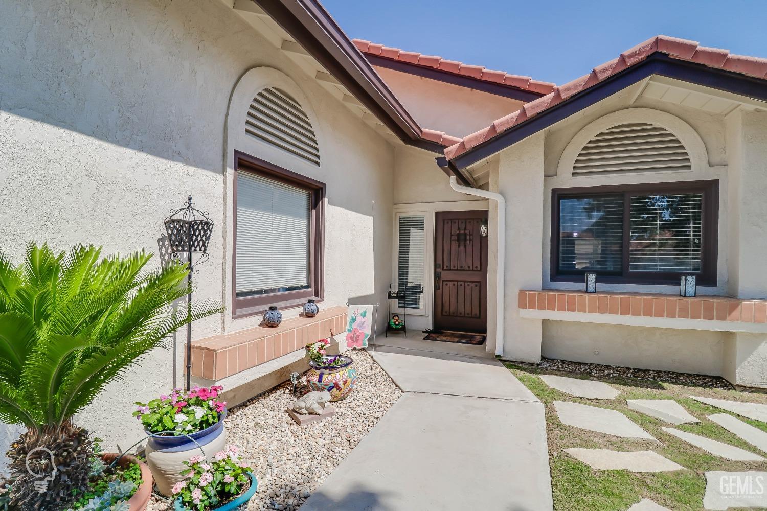 Undisclosed Address Bakersfield, CA 93311 - Photo 5 of 19 a front view of a house with a garden