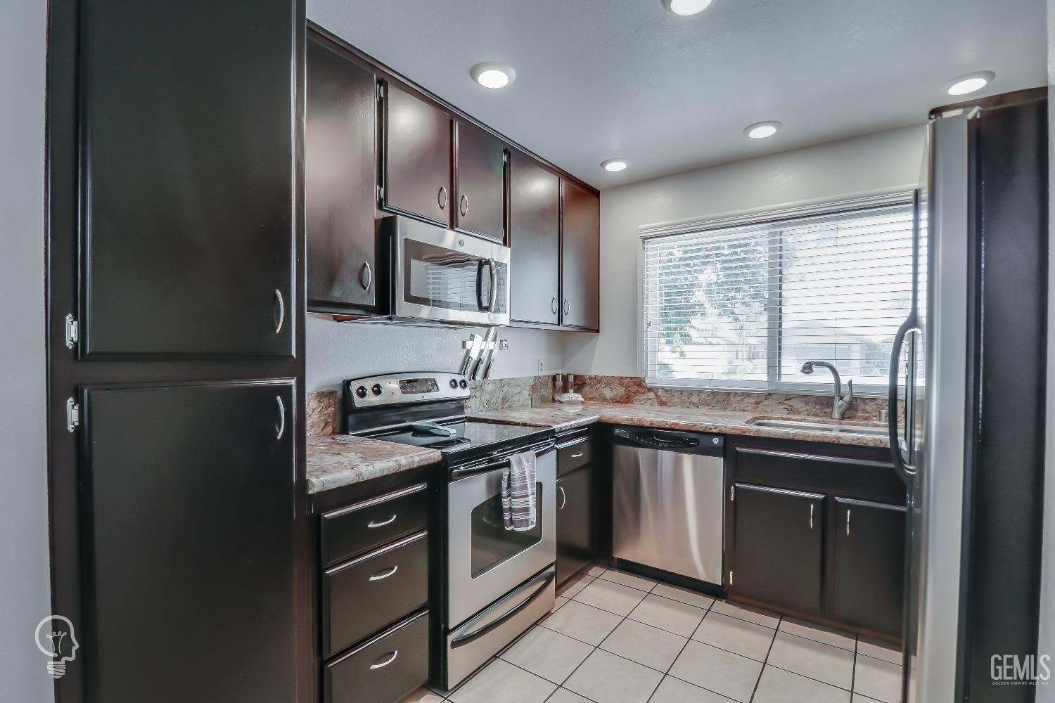 Undisclosed Address Bakersfield, CA 93311 - Photo 9 of 19 a kitchen with stainless steel appliances granite countertop a stove a sink and a refrigerator