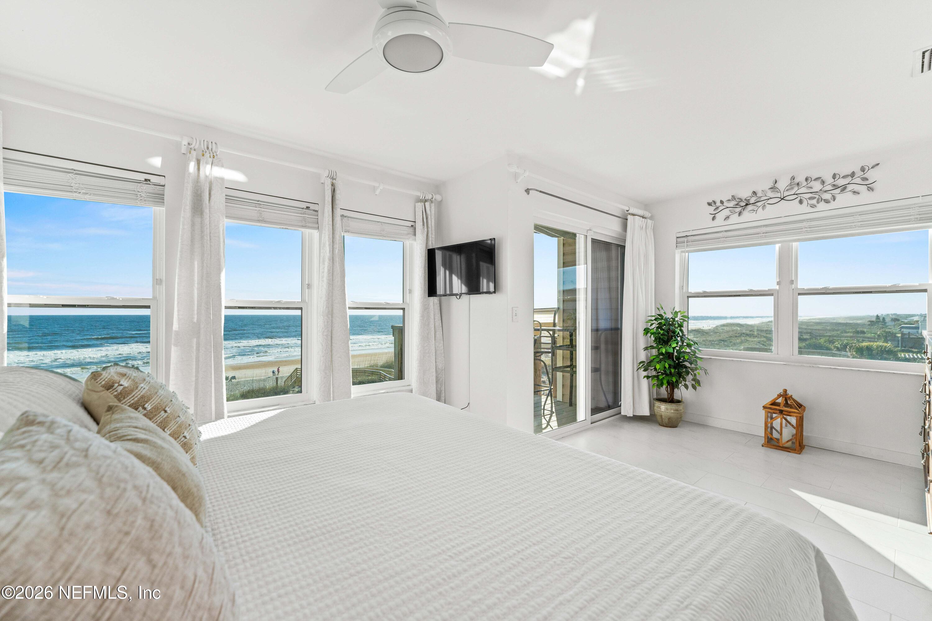 2 10th Street, Unit 6 St. Augustine Beach, FL 32080 - Photo 12 of 40 a spacious bedroom with a large bed and a large window