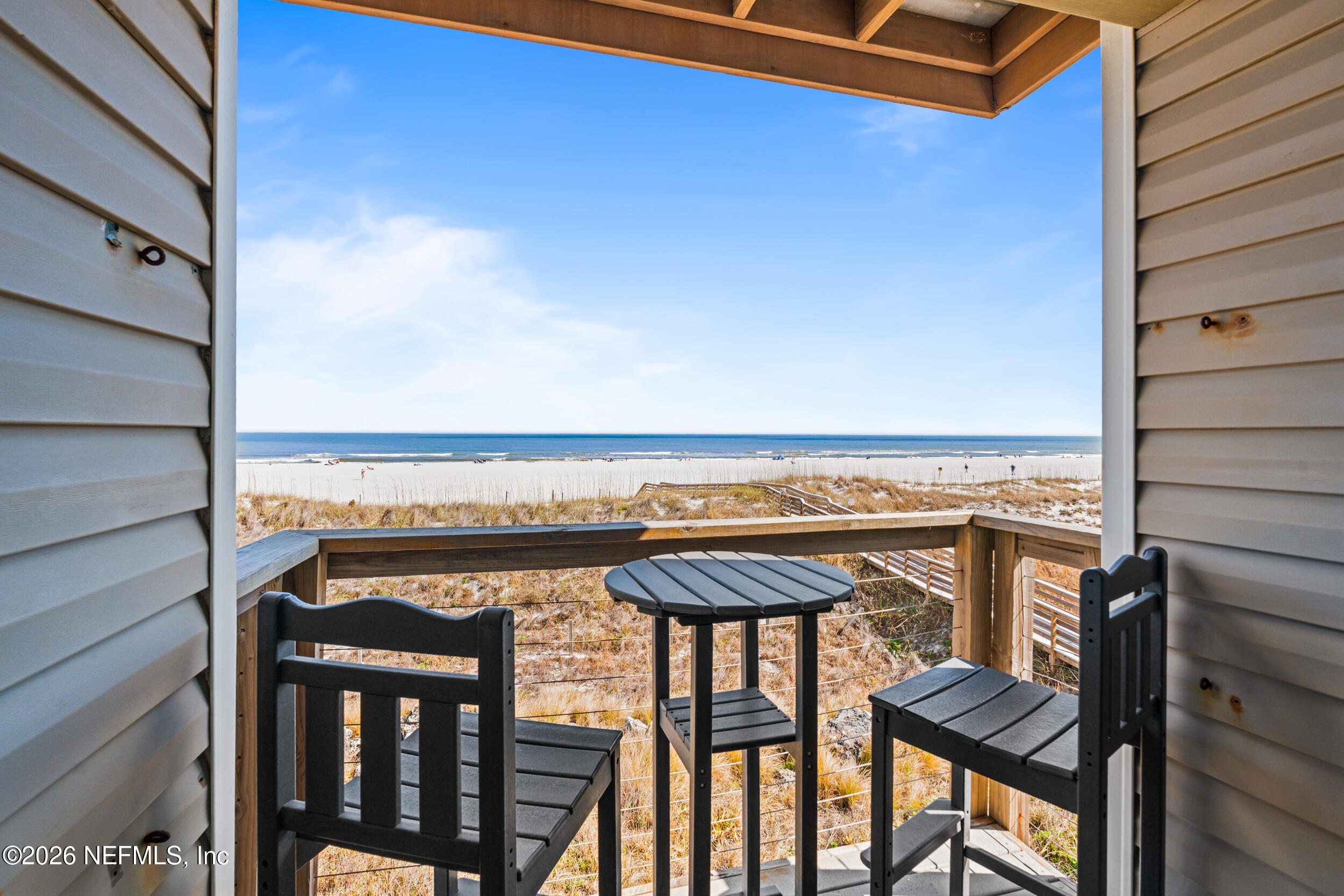 2 10th Street, Unit 6 St. Augustine Beach, FL 32080 - Photo 5 of 40 a view of a balcony with furniture and stove