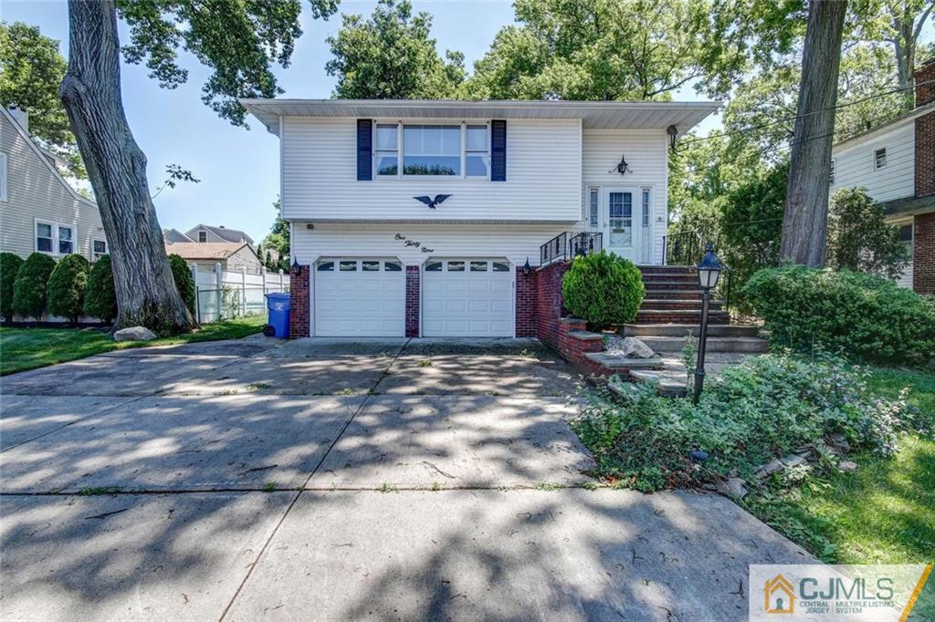 139 East Cliff Road Colonia, NJ 07067 - Photo 1 of 24 a front view of a house with a garden