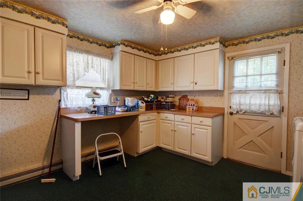 139 East Cliff Road Colonia, NJ 07067 - Photo 14 of 24 a kitchen with granite countertop cabinets stainless steel appliances a sink and a window