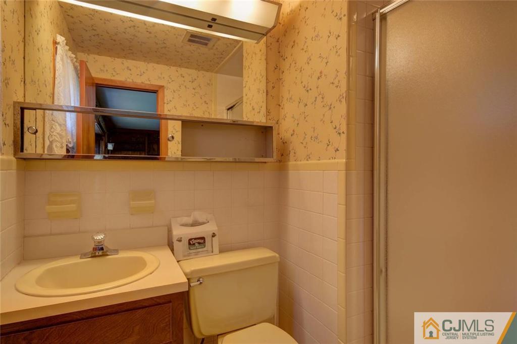 139 East Cliff Road Colonia, NJ 07067 - Photo 17 of 24 a bathroom with a sink and a mirror