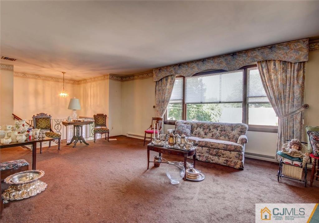 139 East Cliff Road Colonia, NJ 07067 - Photo 3 of 24 a living room with furniture and a large window