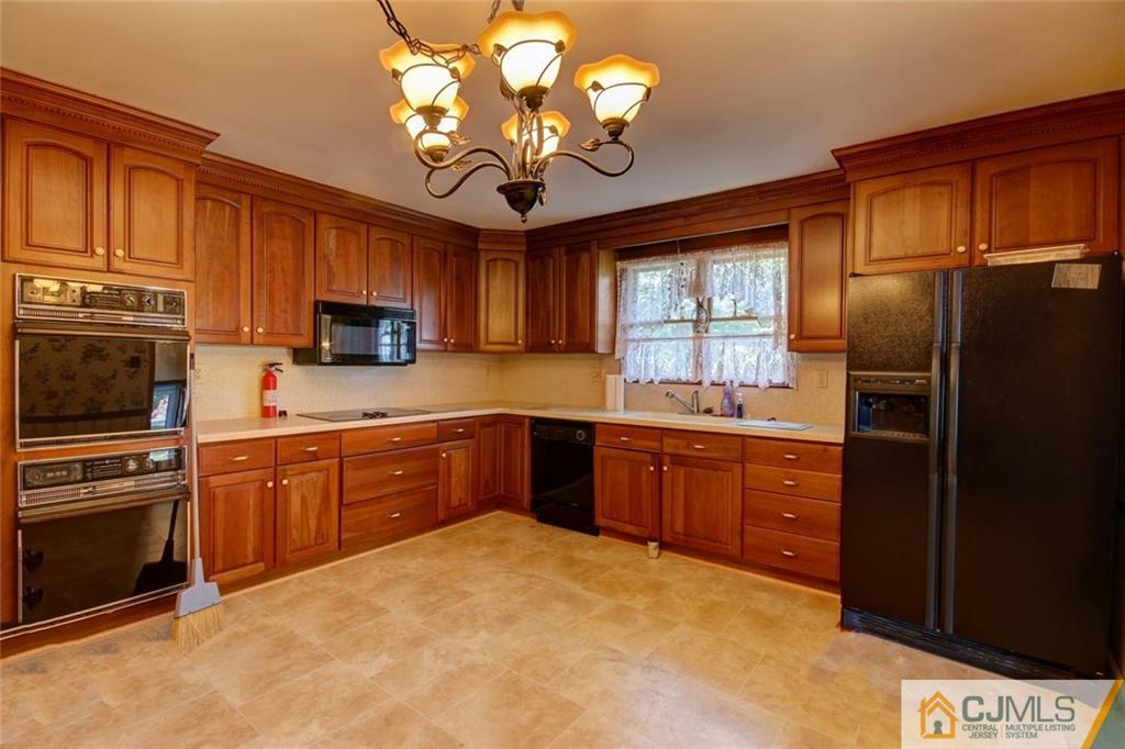 139 East Cliff Road Colonia, NJ 07067 - Photo 7 of 24 a kitchen with stainless steel appliances granite countertop a refrigerator a stove top oven a sink dishwasher and microwave