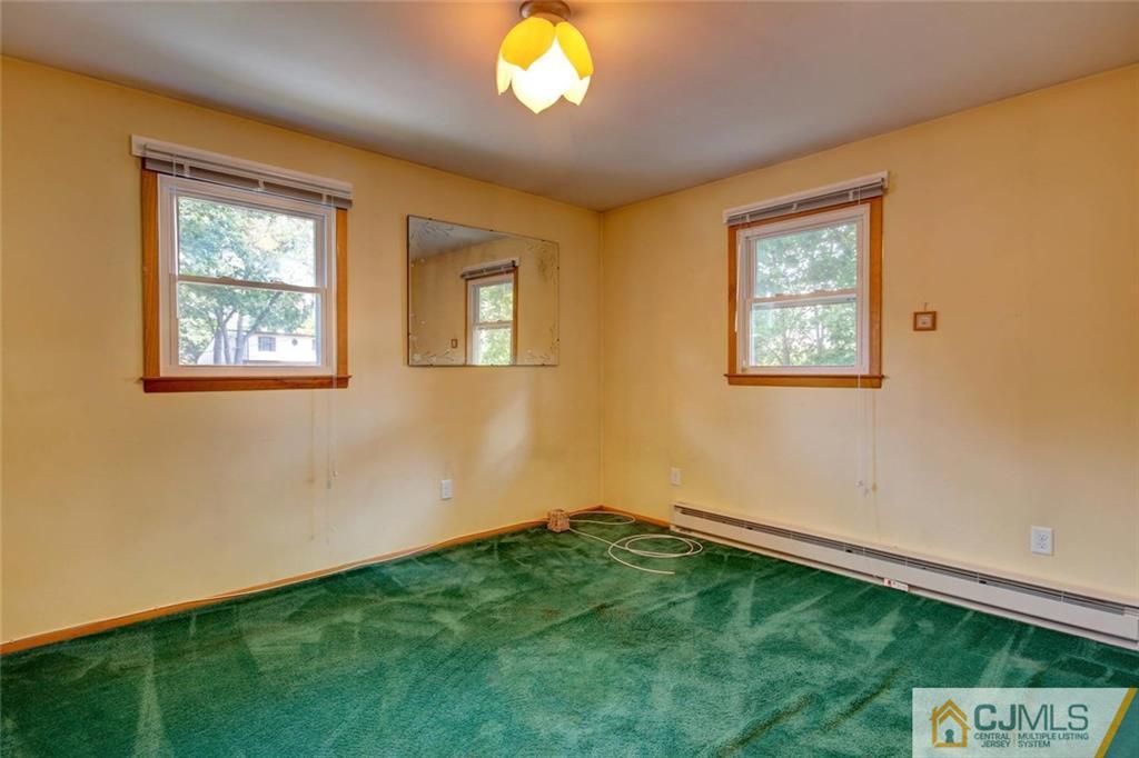 139 East Cliff Road Colonia, NJ 07067 - Photo 10 of 24 a view of an empty room with a window and chandelier fan