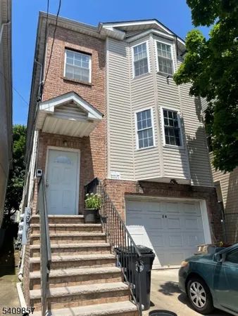 a front view of a house with a garage