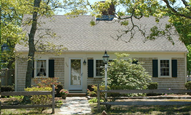 229 Lower County Road West Harwich, MA 02671 - Photo 1 of 23 a front view of a house with lots of trees around