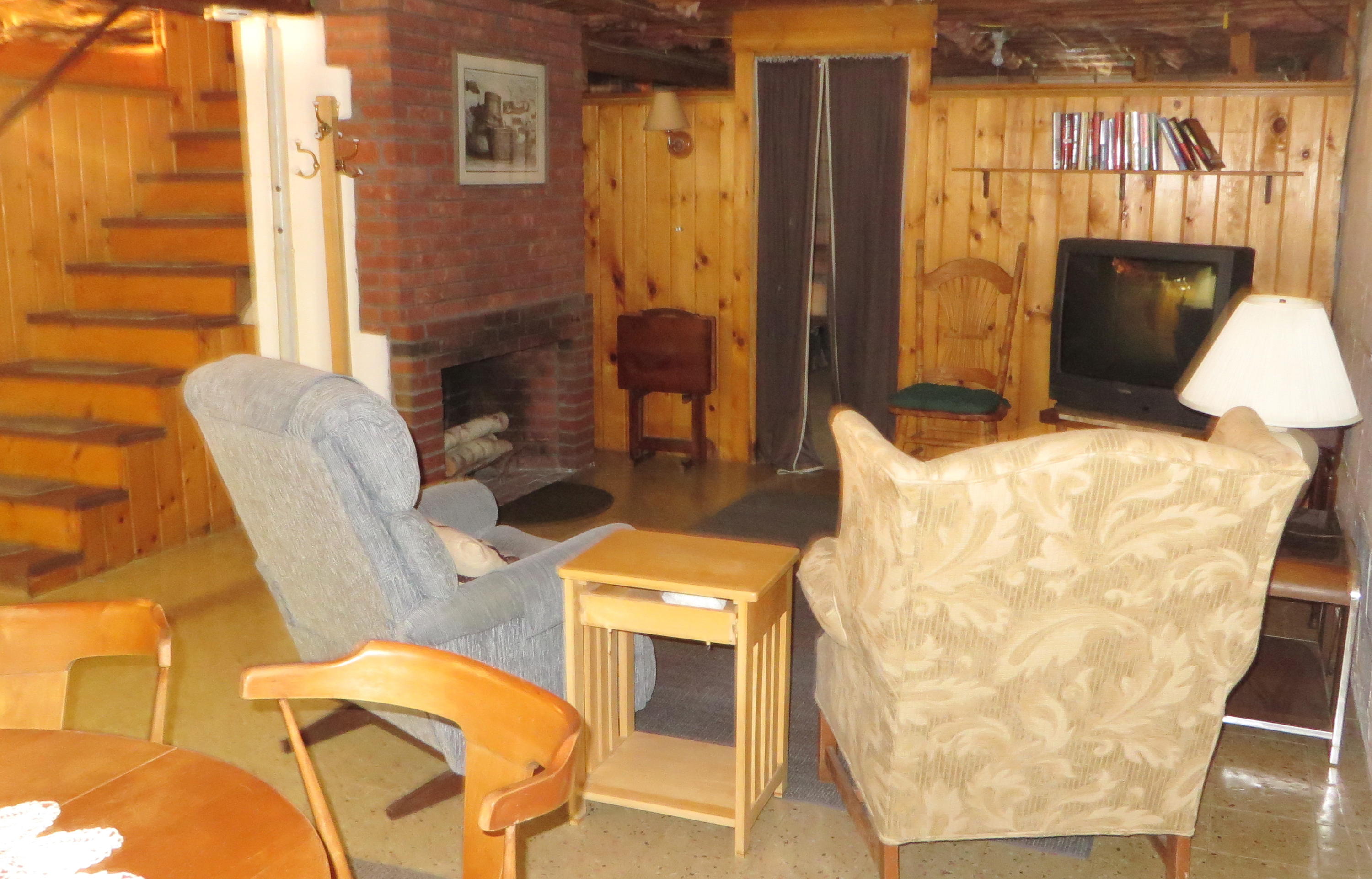 229 Lower County Road West Harwich, MA 02671 - Photo 18 of 23 a living room with furniture and a fireplace