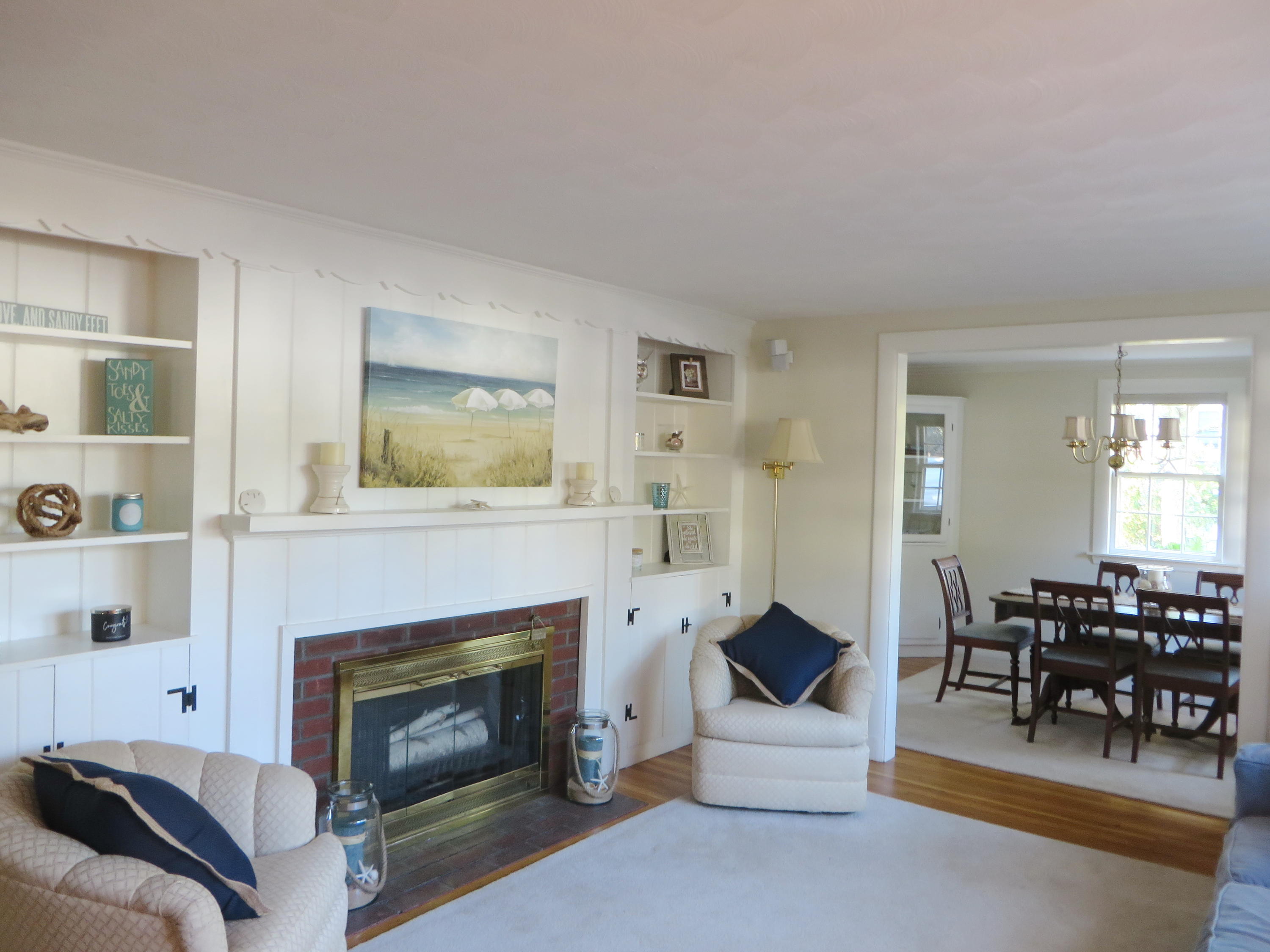 229 Lower County Road West Harwich, MA 02671 - Photo 4 of 23 a living room with furniture and a fireplace