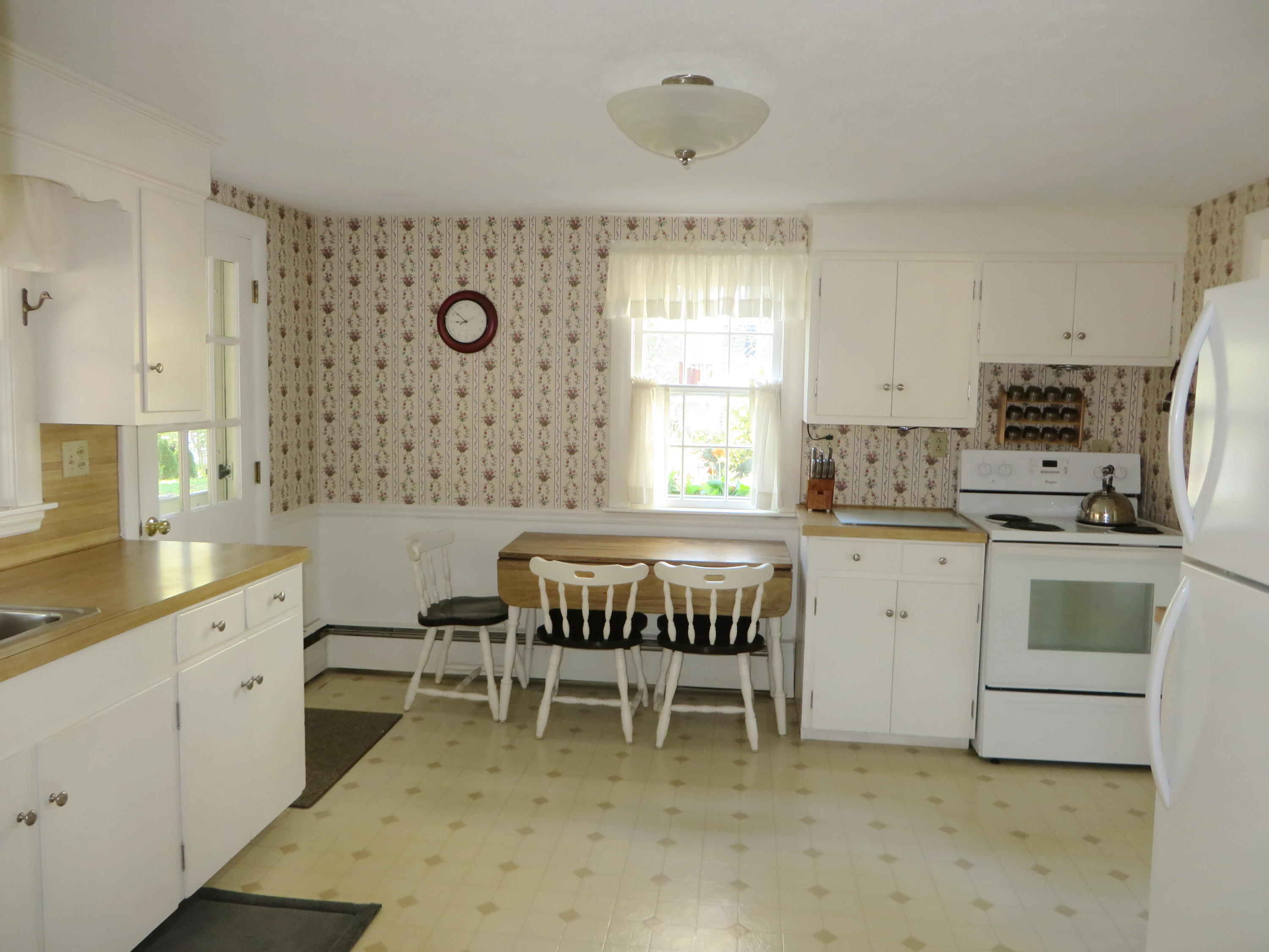 229 Lower County Road West Harwich, MA 02671 - Photo 7 of 23 a kitchen with a white cabinets and chairs