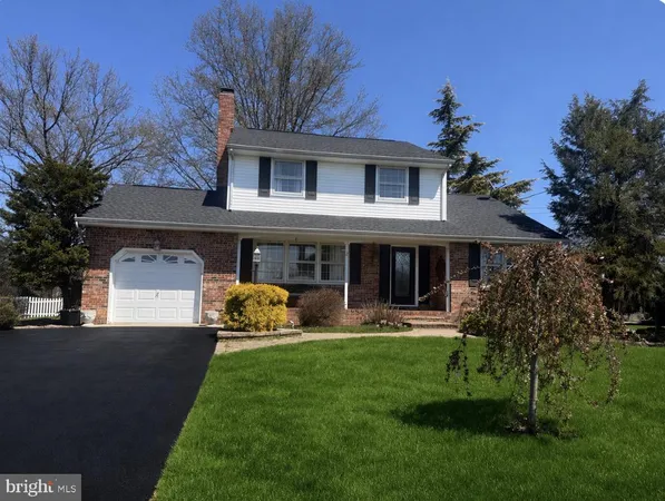 a front view of a house with a garden and plants