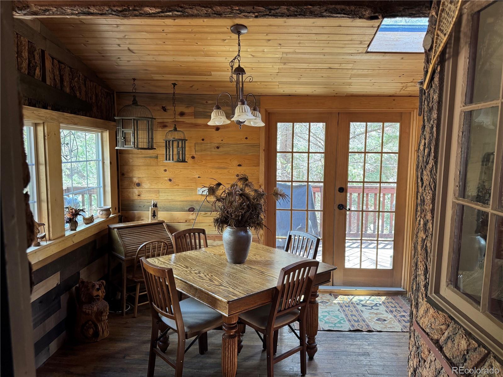 15751 South Elk Creek Road Pine, CO 80470 - Photo 14 of 34 a view of a dining room with furniture window and wooden floor
