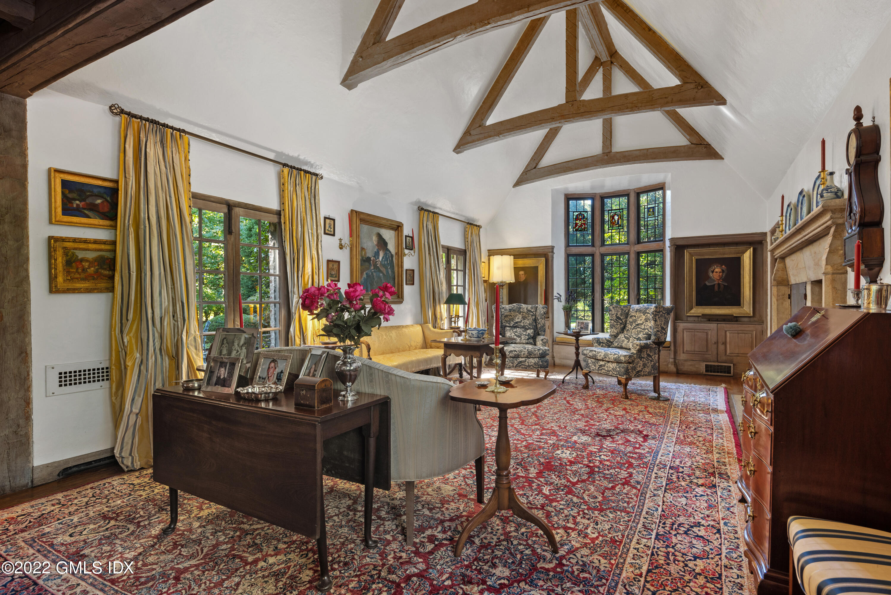 520 Indian Field Road Greenwich, CT 06830 - Photo 18 of 55 a living room with furniture a flat screen tv and a floor to ceiling window