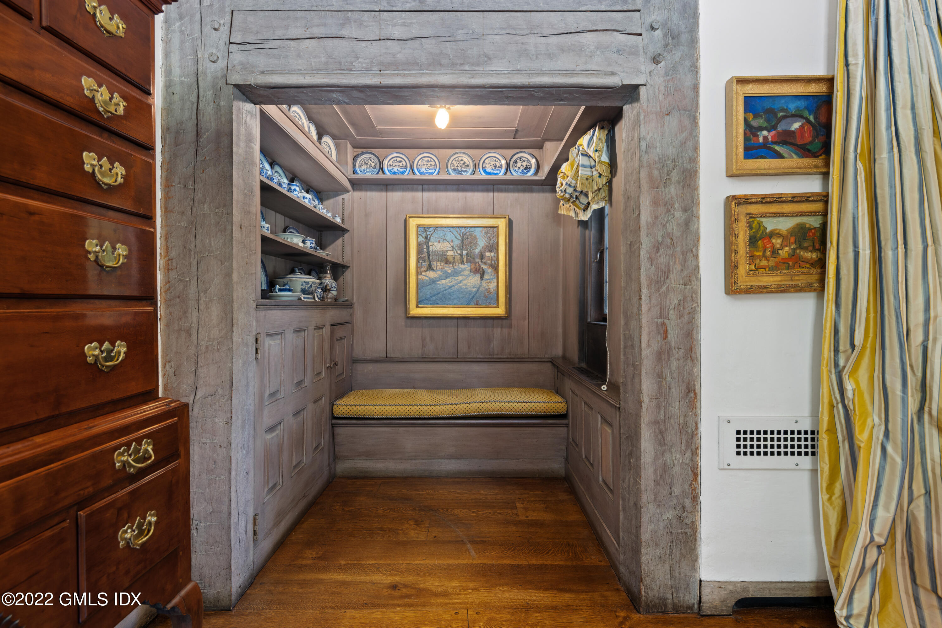 520 Indian Field Road Greenwich, CT 06830 - Photo 24 of 55 a hallway with couches and a bookshelf with wooden floor