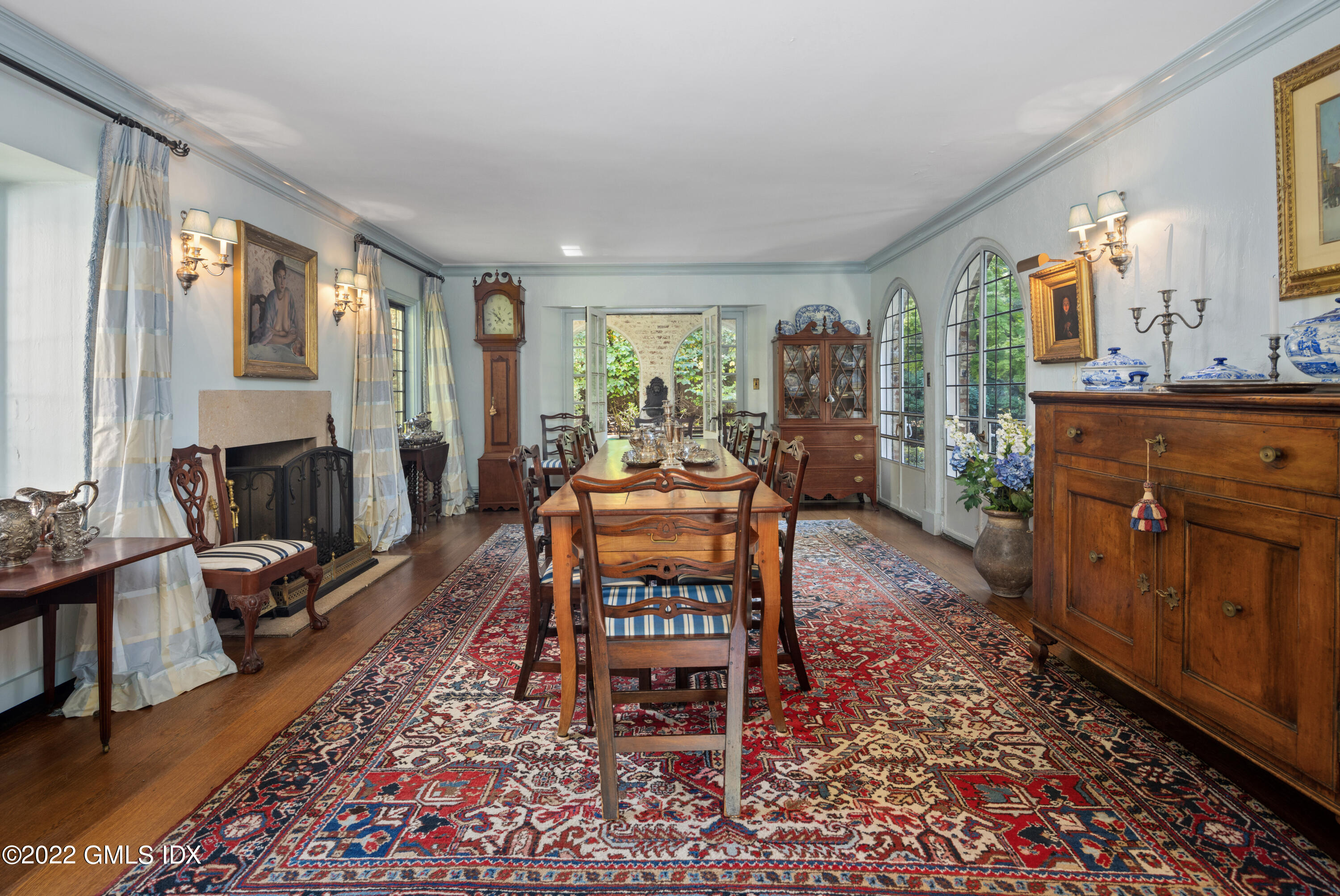 520 Indian Field Road Greenwich, CT 06830 - Photo 30 of 55 a living room with furniture a table and large windows