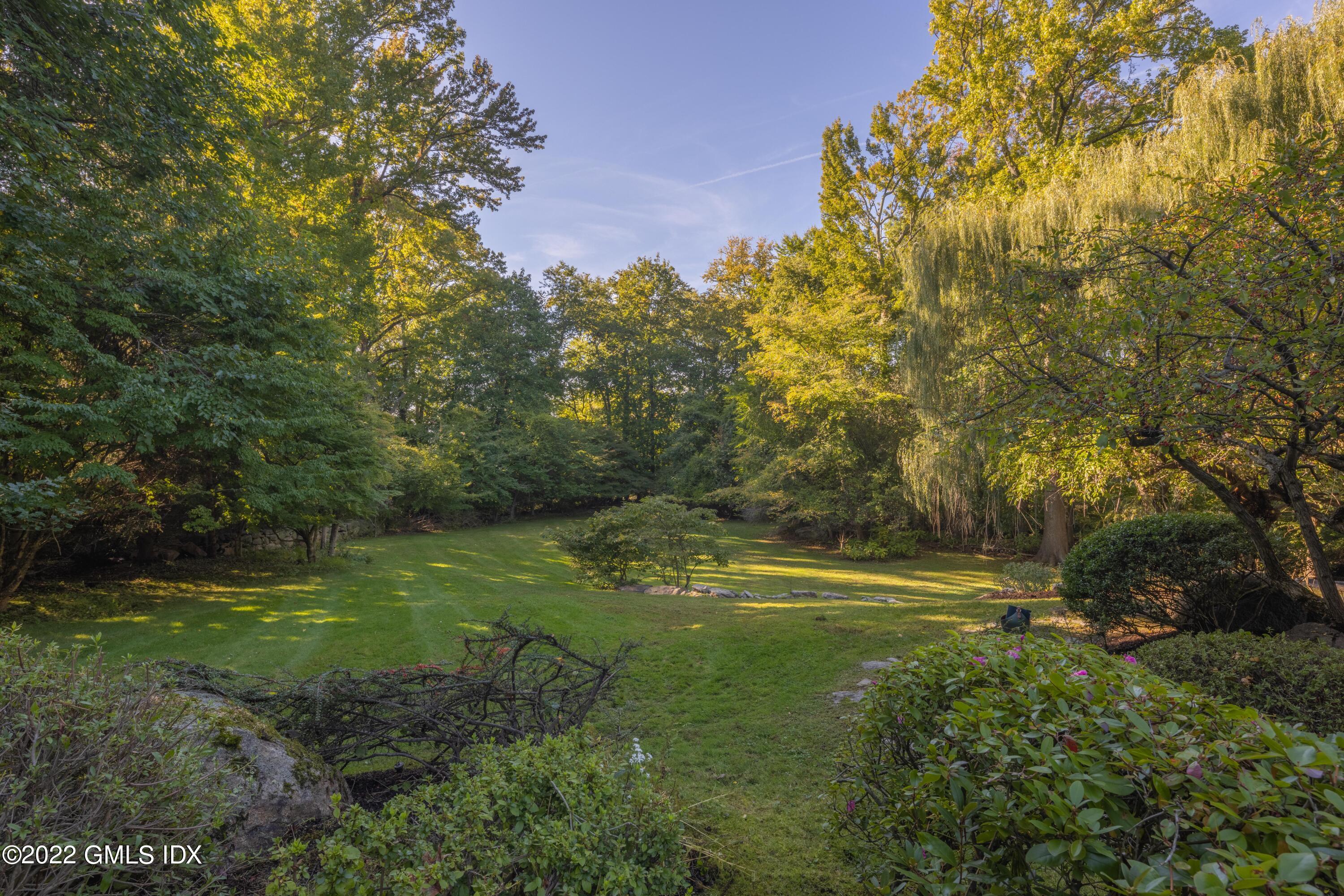 520 Indian Field Road Greenwich, CT 06830 - Photo 45 of 55 a view of outdoor space with deck and green space