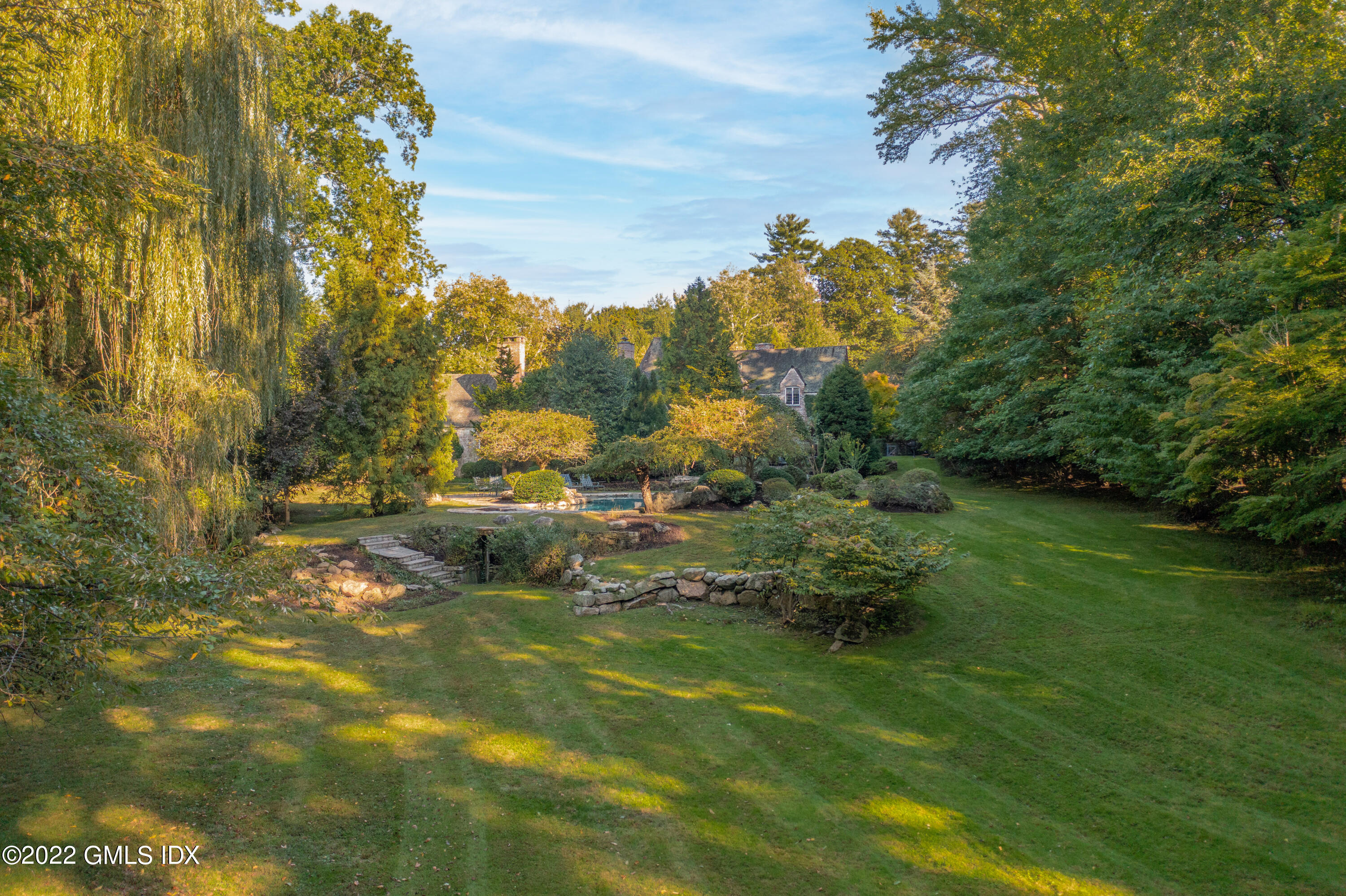 520 Indian Field Road Greenwich, CT 06830 - Photo 46 of 55 a view of a golf course with a lake