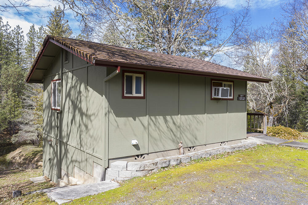1735 Robertson Bridge Road Grants Pass, OR 97526 - Photo 28 of 47 a view of a wooden house with a large tree