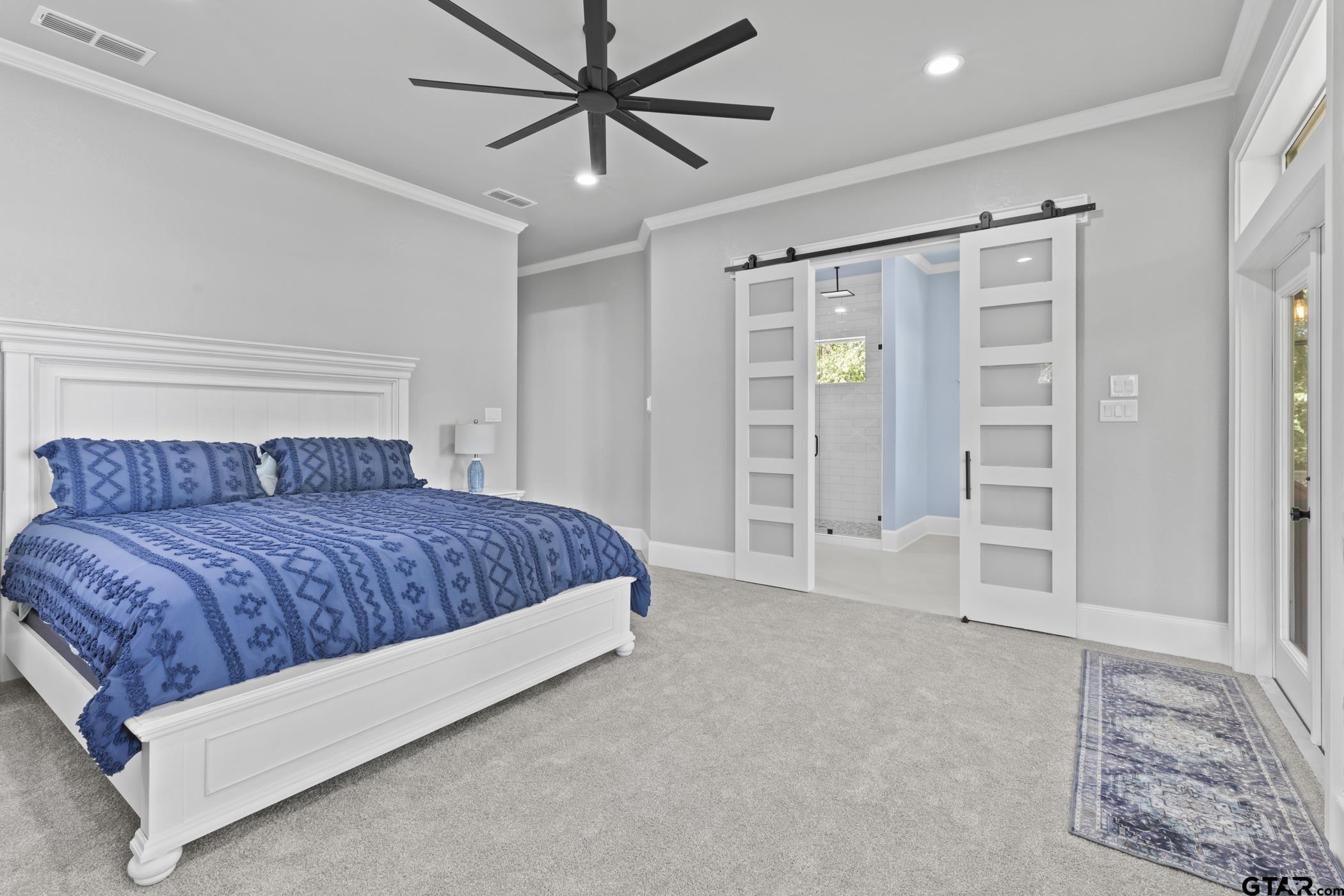 18630 Eastside Road Troup, TX 75789 - Photo 24 of 47 a spacious bedroom with a large bed and a ceiling fan