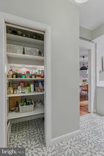 a room with water heater and shelf