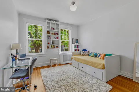 a bedroom with furniture and a window