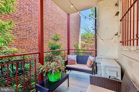 a view of a balcony with furniture