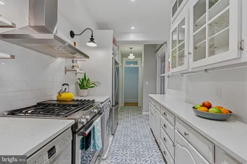 a kitchen with a stove and a wooden cabinets