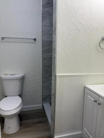 a bathroom with a toilet and a shower