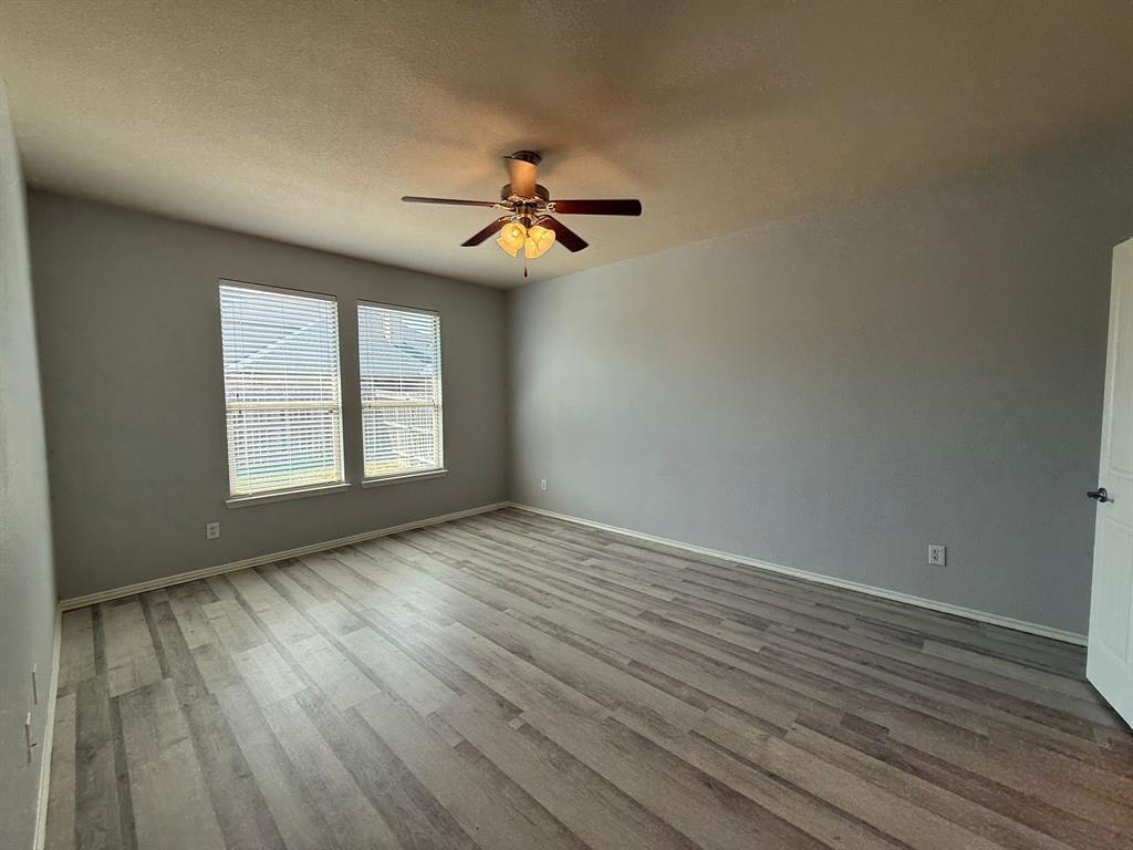 2047 Jack County Drive Forney, TX 75126 - Photo 12 of 20 wooden floor in an empty room with a window