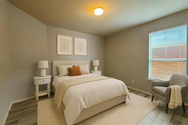 a bedroom with a bed and chair