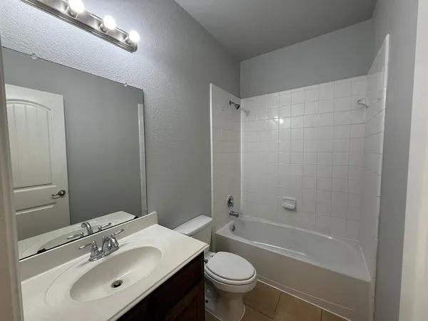 a bedroom with a bed and a ceiling fan