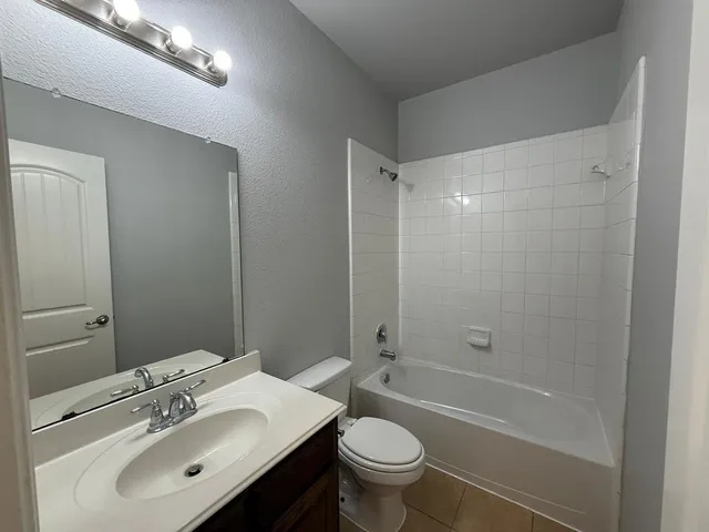 a bedroom with a bed and a ceiling fan