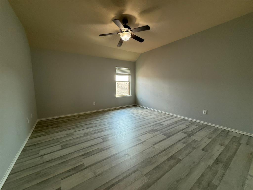 2047 Jack County Drive Forney, TX 75126 - Photo 20 of 20 a view of an empty room with wooden floor and a window