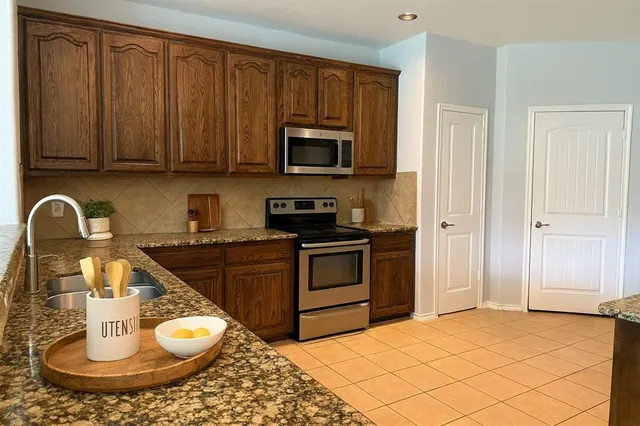 a kitchen with a appliances and cabinets