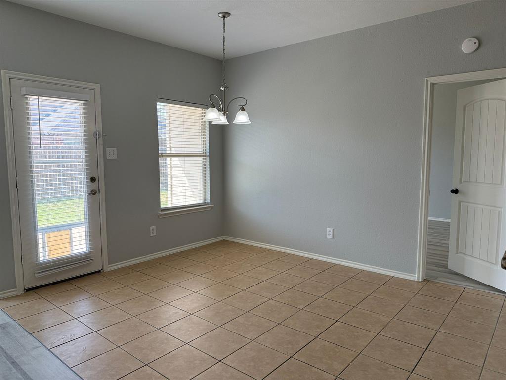 2047 Jack County Drive Forney, TX 75126 - Photo 8 of 20 an empty room with chandelier fan and windows