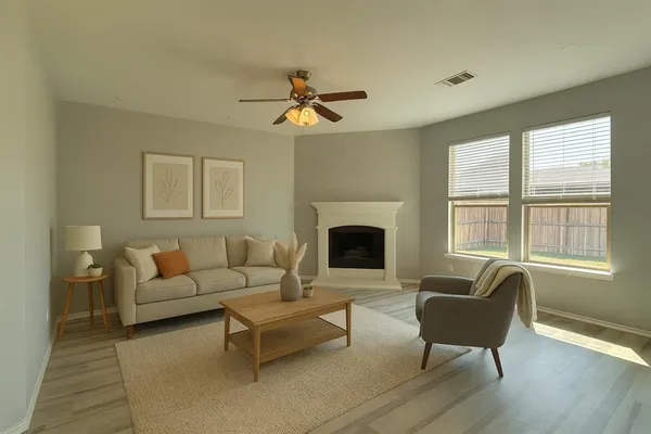 a living room with furniture a fireplace and a window