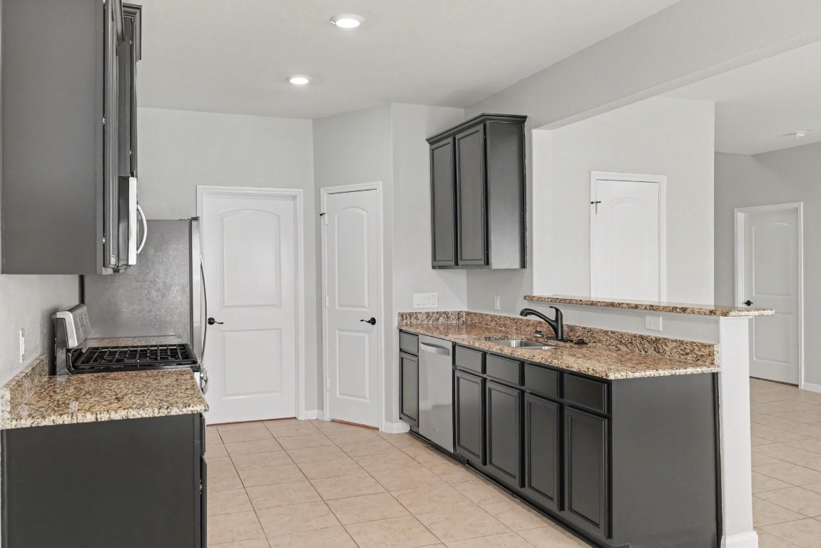 7722 Boulder Sunstone Lane Conroe, TX 77304 - Photo 11 of 25 a bathroom with a granite countertop sink and a mirror