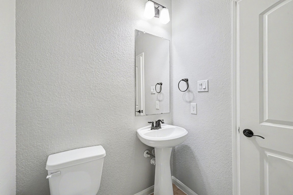 7722 Boulder Sunstone Lane Conroe, TX 77304 - Photo 15 of 25 a bathroom with a sink toilet and a mirror