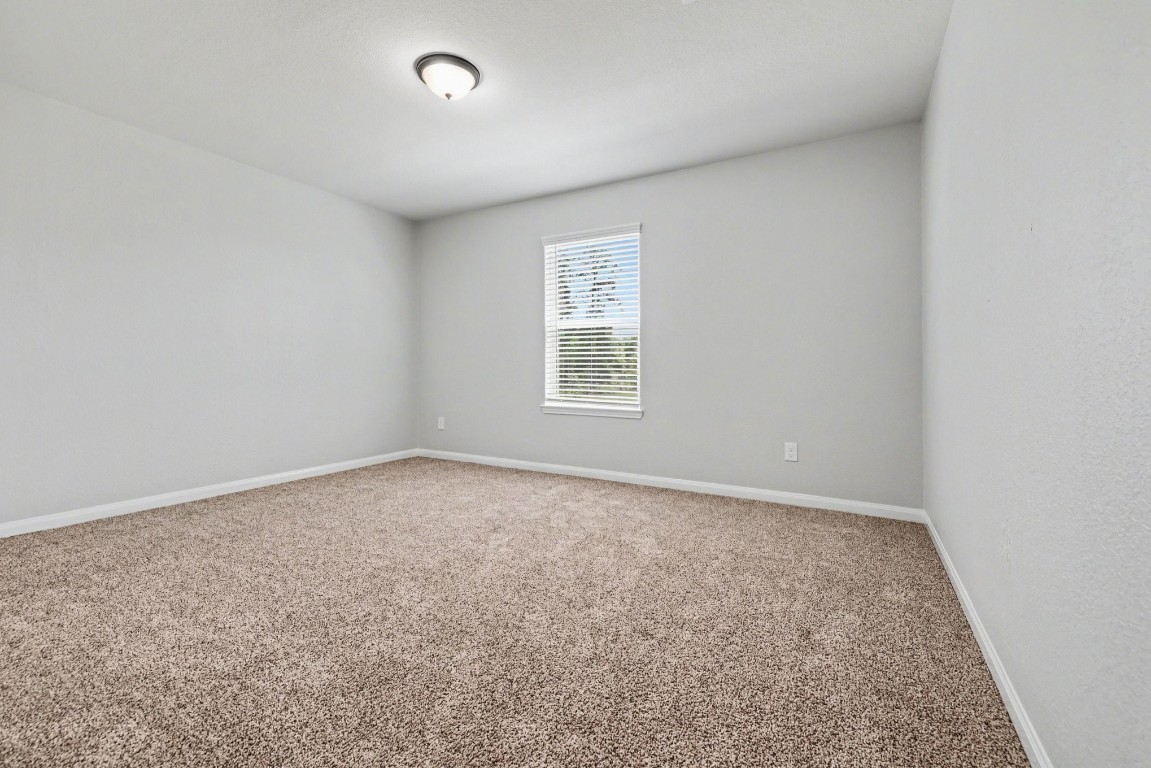 7722 Boulder Sunstone Lane Conroe, TX 77304 - Photo 20 of 25 an empty room with a window