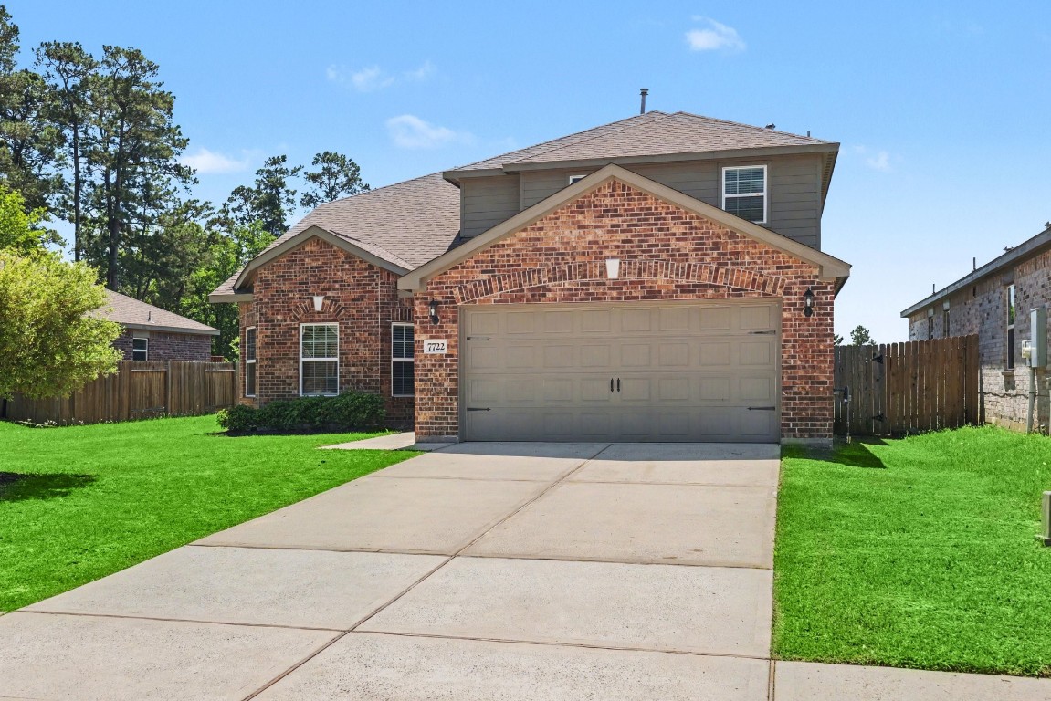 7722 Boulder Sunstone Lane Conroe, TX 77304 - Photo 2 of 25 a front view of a house with a yard