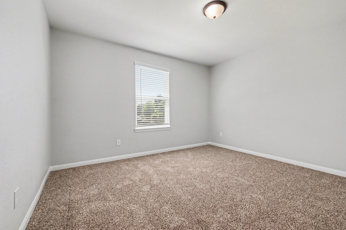 7722 Boulder Sunstone Lane Conroe, TX 77304 - Photo 21 of 25 an empty room with windows